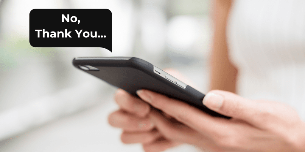 Do keep it short and don't draw out a long explanation for why you don't want to continue dating. A woman holds her phone with a text that reads, "No, thank you."